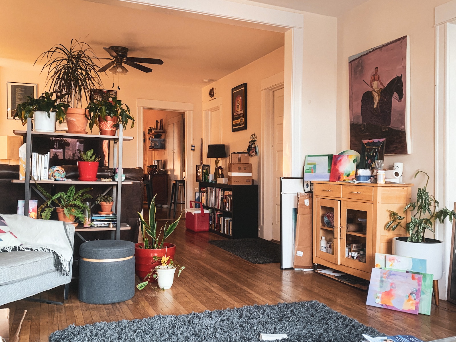 a living room filled with furniture and lots of plants